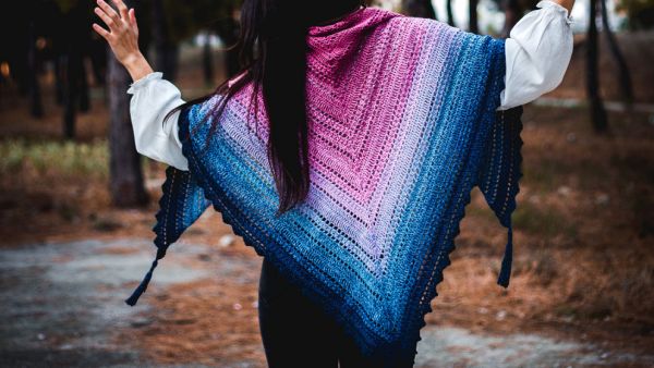 the back of a girl wearing a handmade crochet shawl